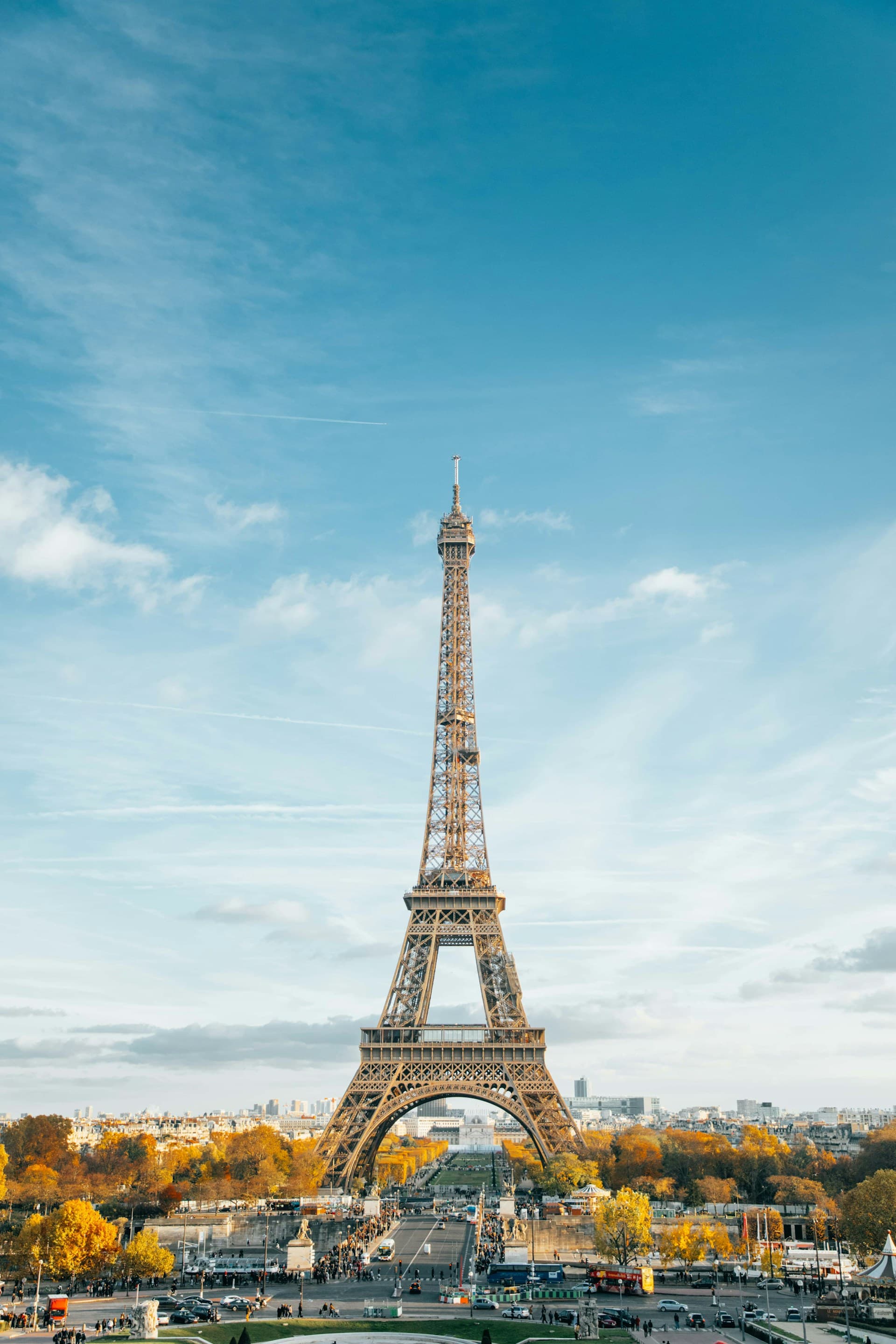 The Eiffel Tower against a blue sky with autumn foliage